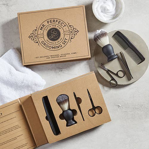 Grooming set with tools and packaging on a light surface